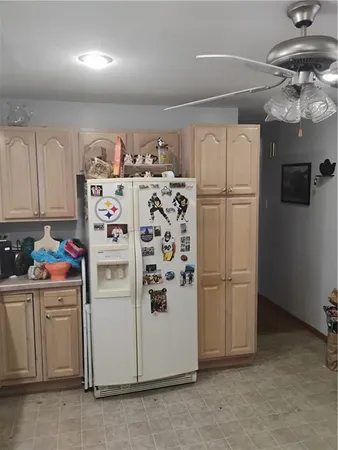 a kitchen with refrigerator and cabinets