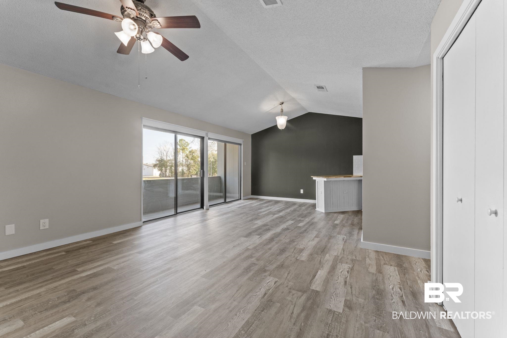 128 West Satsuma Avenue, Unit 128 Foley, AL 36535 - Photo 5 of 41 Unfurnished living room featuring ceiling fan and light wood-style flooring