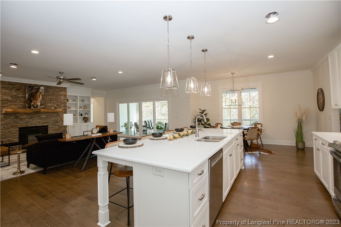1365 McCaskill Road Carthage, NC 28327 - Photo 16 of 50 a kitchen with a sink a stove and chairs