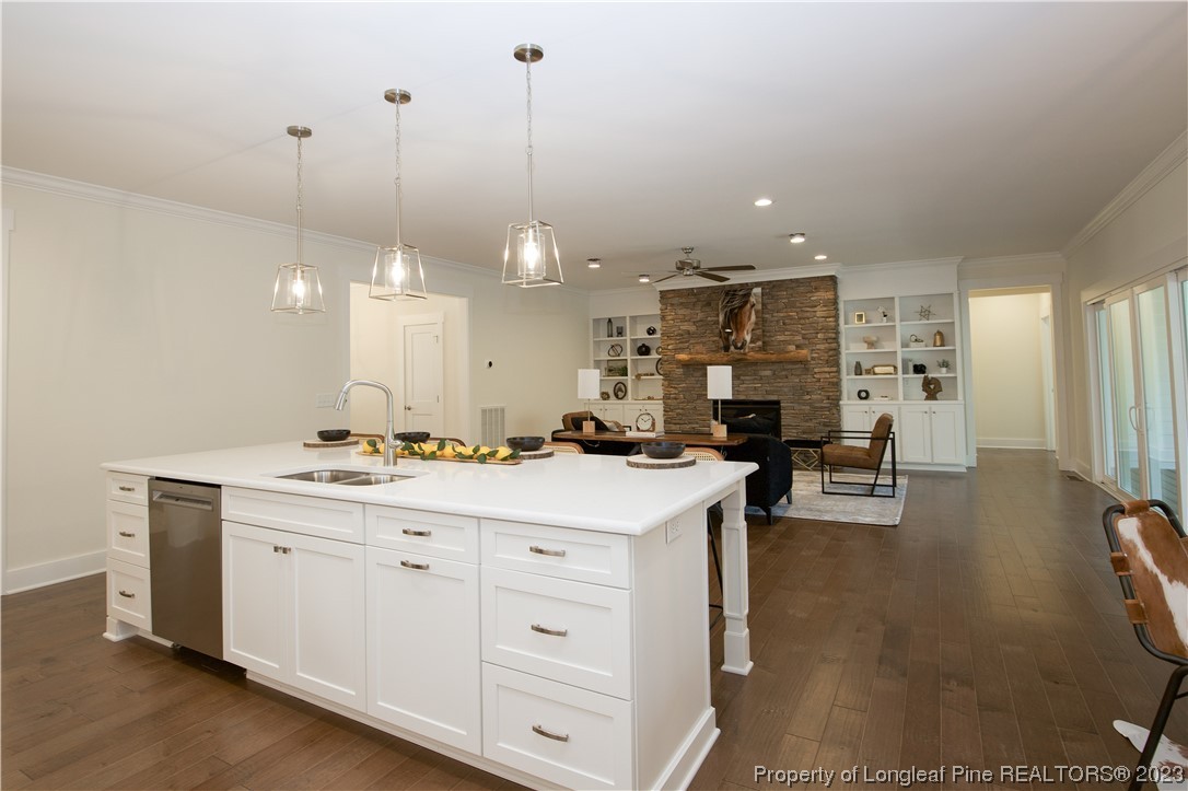 1365 McCaskill Road Carthage, NC 28327 - Photo 17 of 50 a open kitchen with kitchen island a stove a sink a center island and wooden floor