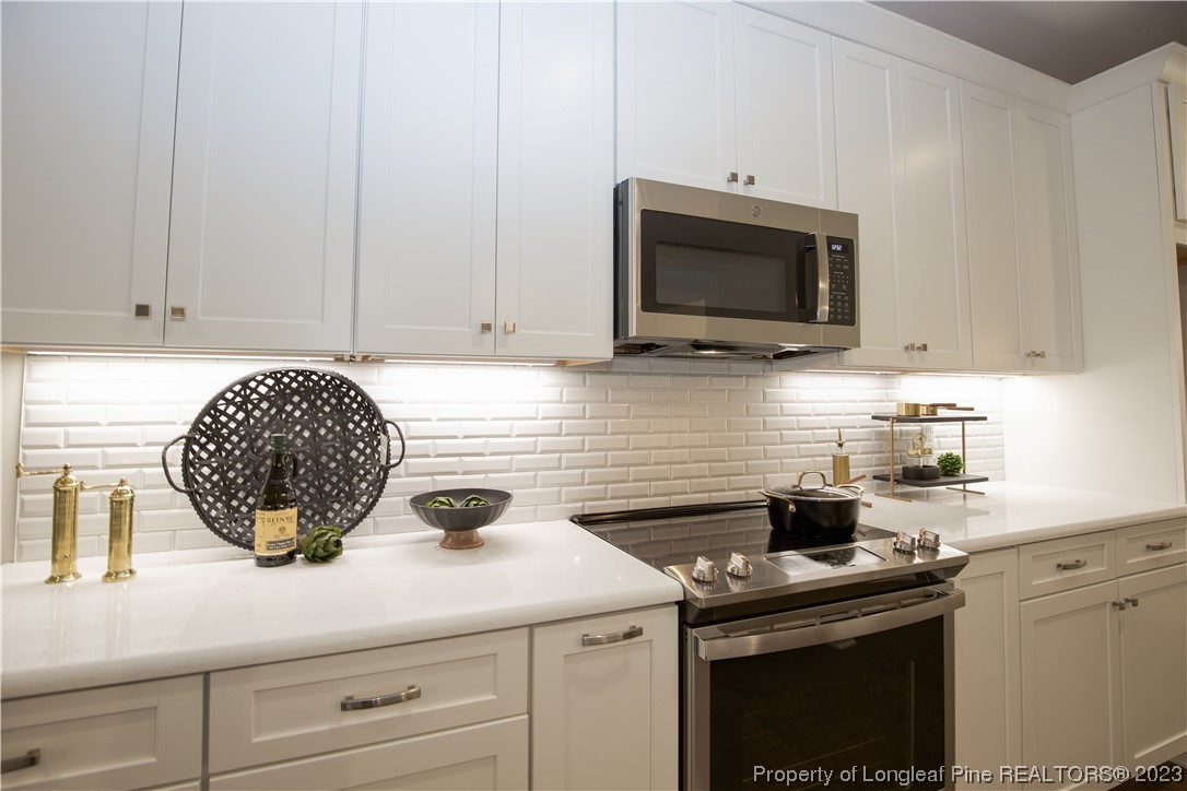 1365 McCaskill Road Carthage, NC 28327 - Photo 19 of 50 a kitchen with a stove and a microwave