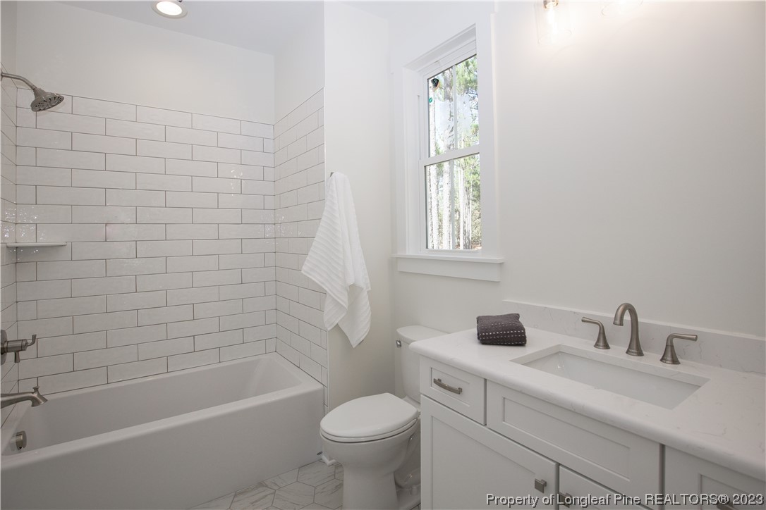 1365 McCaskill Road Carthage, NC 28327 - Photo 24 of 50 a bathroom with a sink toilet and bathtub