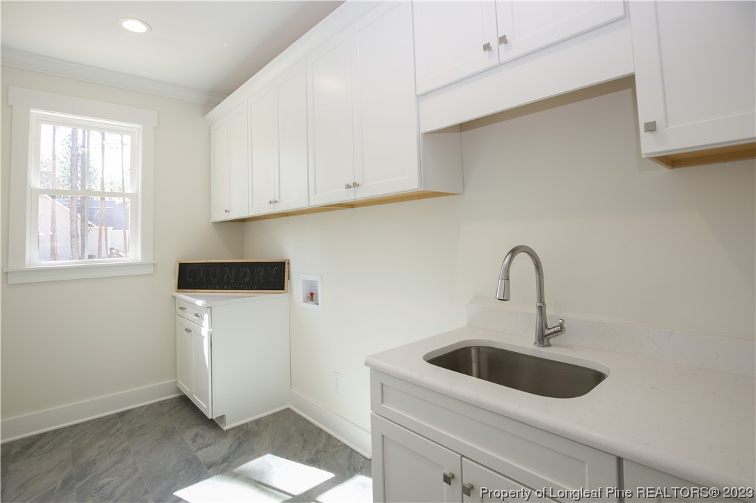 1365 McCaskill Road Carthage, NC 28327 - Photo 31 of 50 a kitchen with a sink and a washer dryer