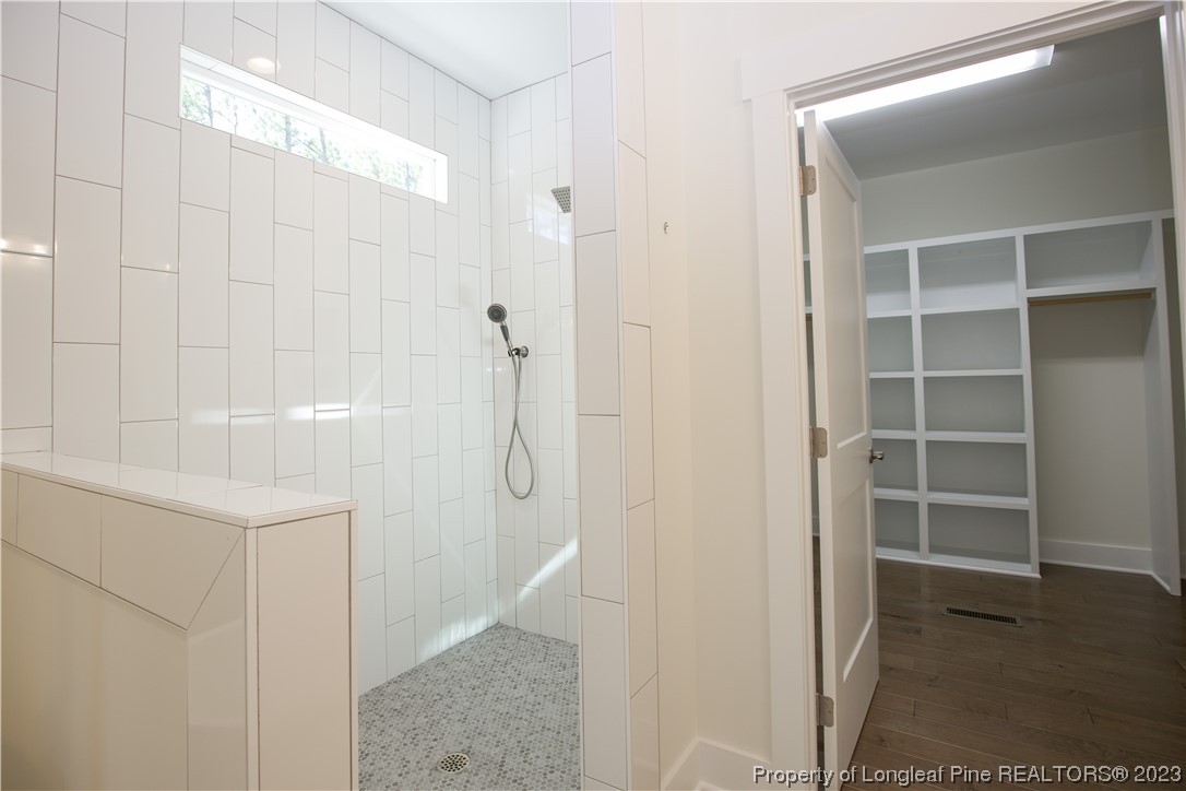 1365 McCaskill Road Carthage, NC 28327 - Photo 38 of 50 a bathroom with a shower and a glass door