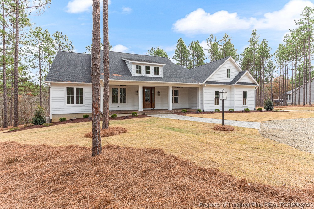 1365 McCaskill Road Carthage, NC 28327 - Photo 4 of 50 a house with palm tree in front of it
