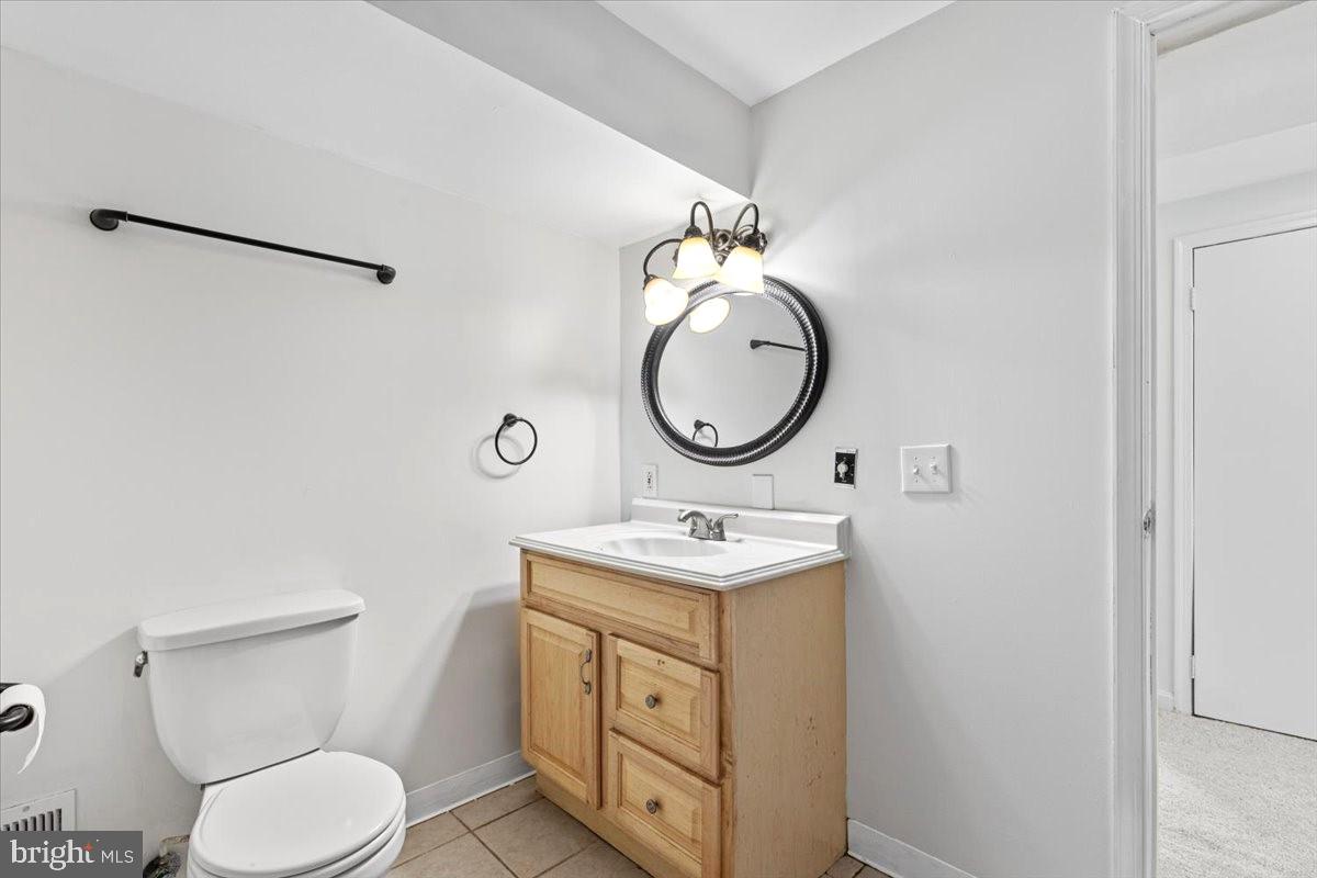 11654 Kipling Drive Waldorf, MD 20601 - Photo 22 of 33 a bathroom with a toilet sink vanity and mirror