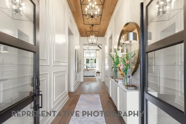 a view of entryway and hall with wooden floor