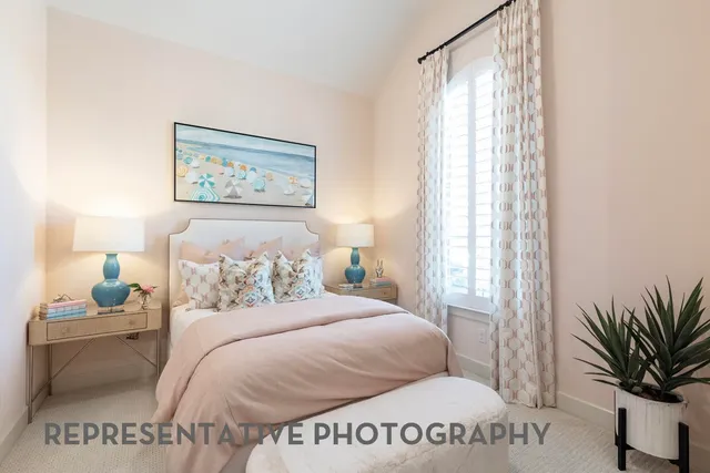 a bedroom with a bed and a potted plant