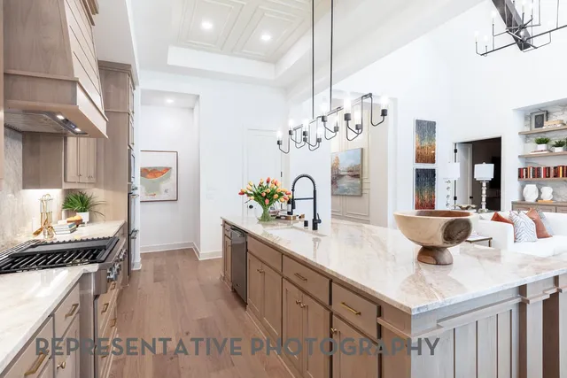 a kitchen with counter top space and wooden floor