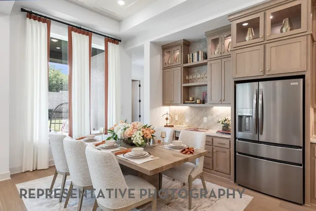 a kitchen with stainless steel appliances granite countertop a refrigerator and microwave