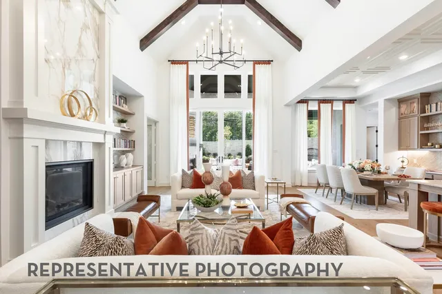 a living room with furniture a fireplace and a chandelier