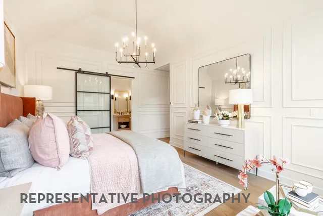 a bedroom with a bed and a chandelier