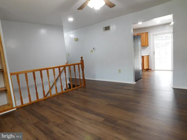 a view of hallway with wooden floor
