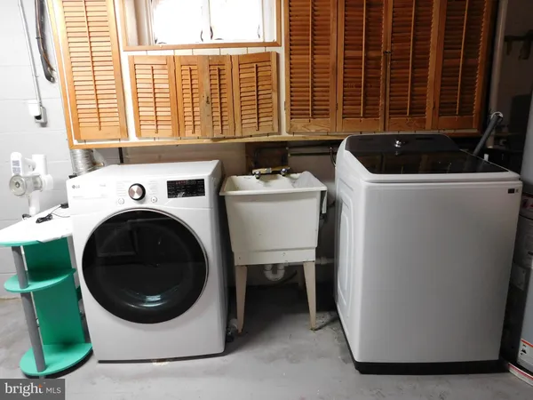 a utility room with sink washer and dryer