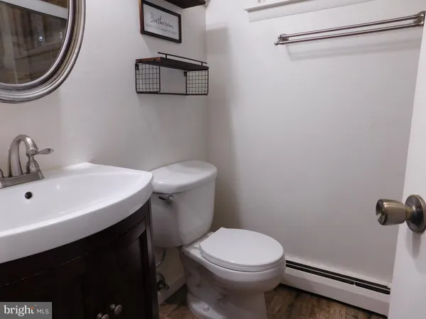 a bathroom with a sink a toilet and a mirror