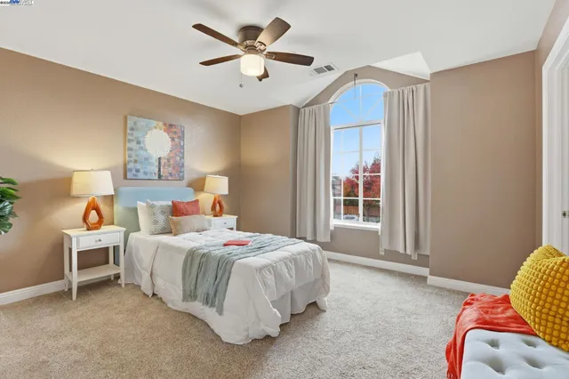 a bedroom with a bed and a window