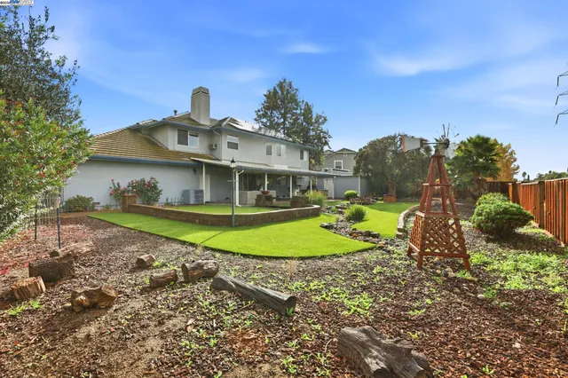a backyard of a house with lots of green space and garden