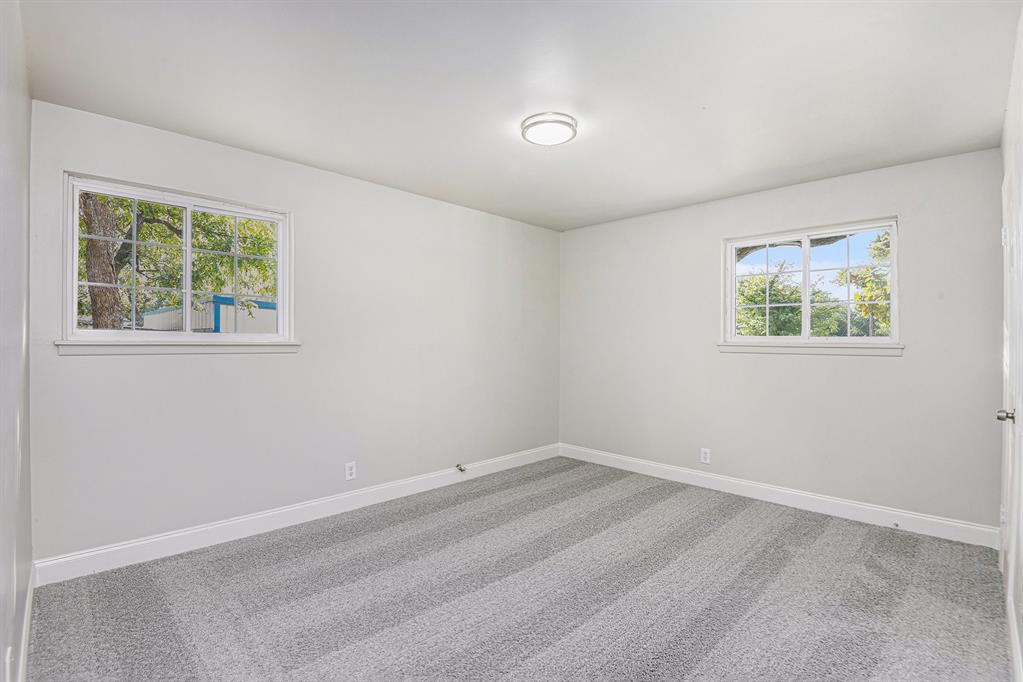 233 Victoria Avenue Azle, TX 76020 - Photo 13 of 25 Unfurnished room featuring light colored carpet and baseboards
