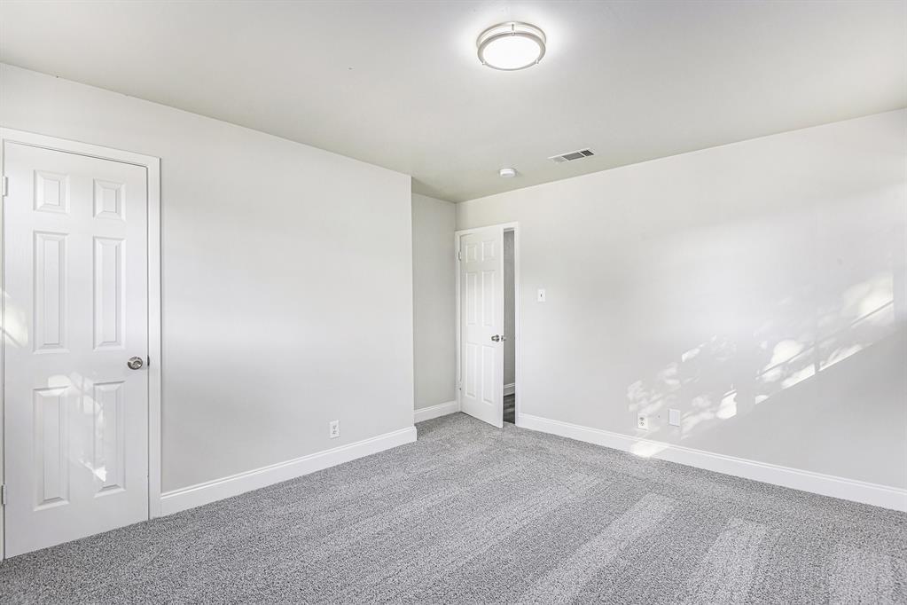 233 Victoria Avenue Azle, TX 76020 - Photo 14 of 25 Carpeted empty room featuring baseboards