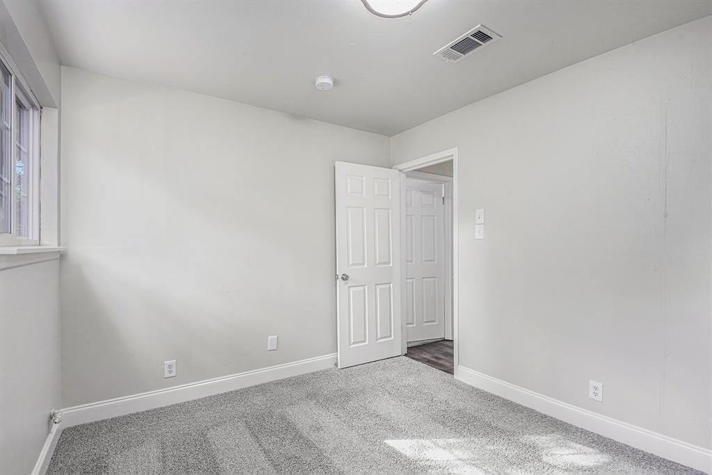233 Victoria Avenue Azle, TX 76020 - Photo 16 of 25 Carpeted empty room featuring baseboards