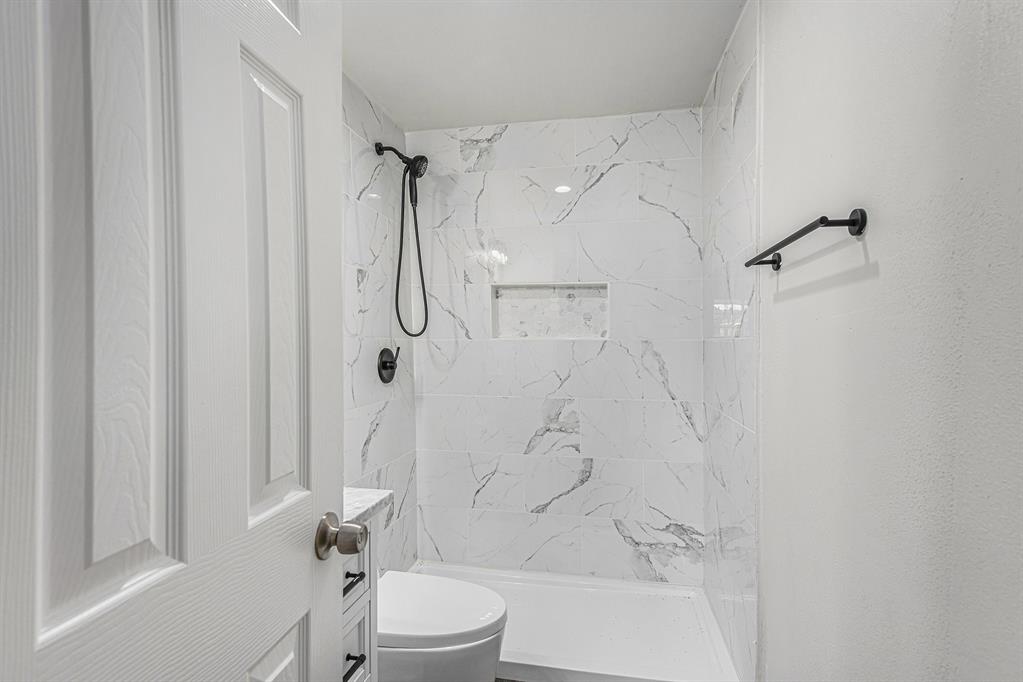 233 Victoria Avenue Azle, TX 76020 - Photo 17 of 25 Bathroom with a marble finish shower and toilet