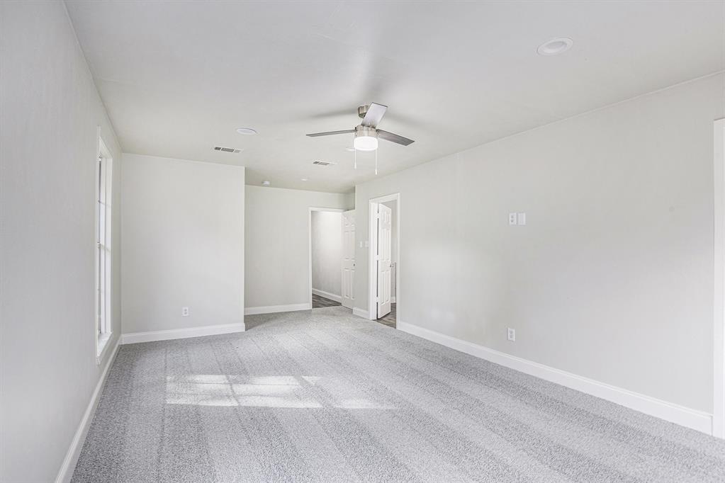 233 Victoria Avenue Azle, TX 76020 - Photo 20 of 25 Empty room featuring light carpet and a ceiling fan