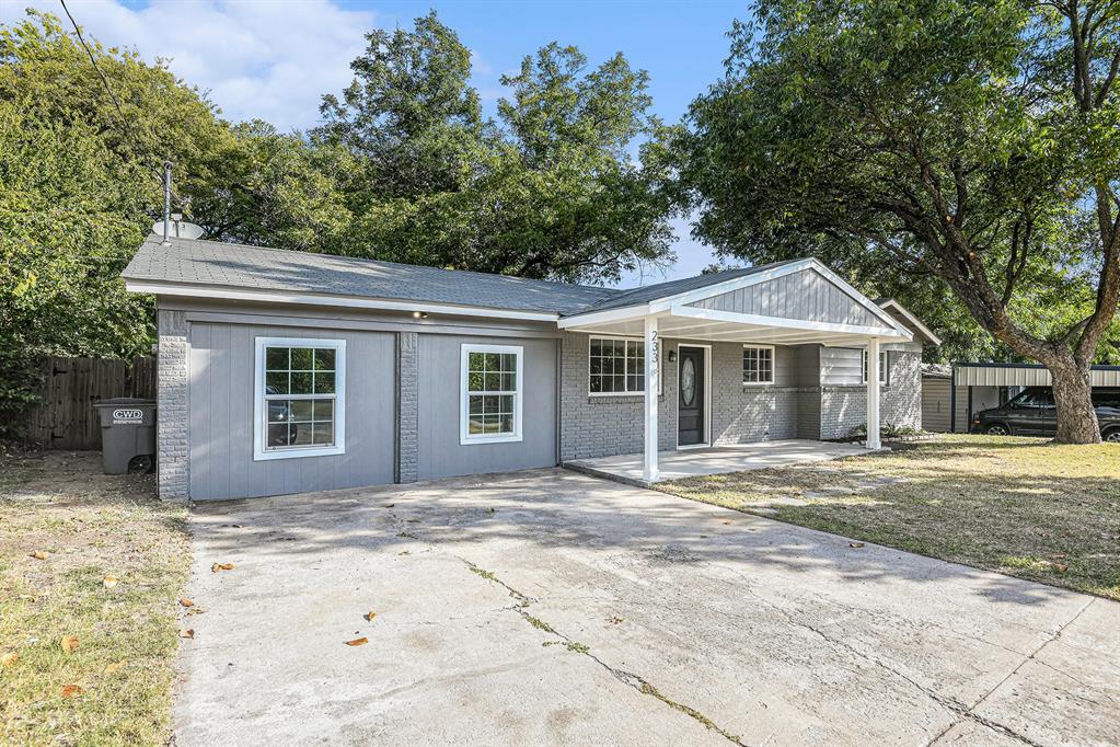 233 Victoria Avenue Azle, TX 76020 - Photo 2 of 25 Ranch-style house with covered porch, brick siding, roof with shingles, and concrete driveway