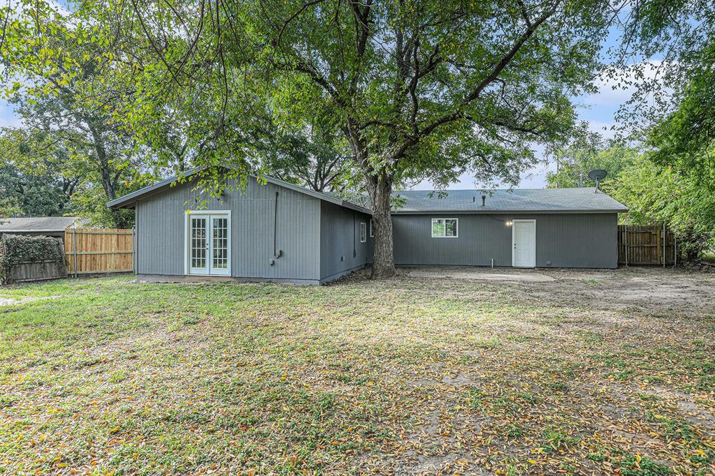 233 Victoria Avenue Azle, TX 76020 - Photo 25 of 25 Rear view of house with a fenced backyard and french doors