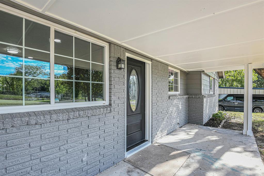 233 Victoria Avenue Azle, TX 76020 - Photo 3 of 25 Entrance to property featuring covered porch, brick siding, and a carport