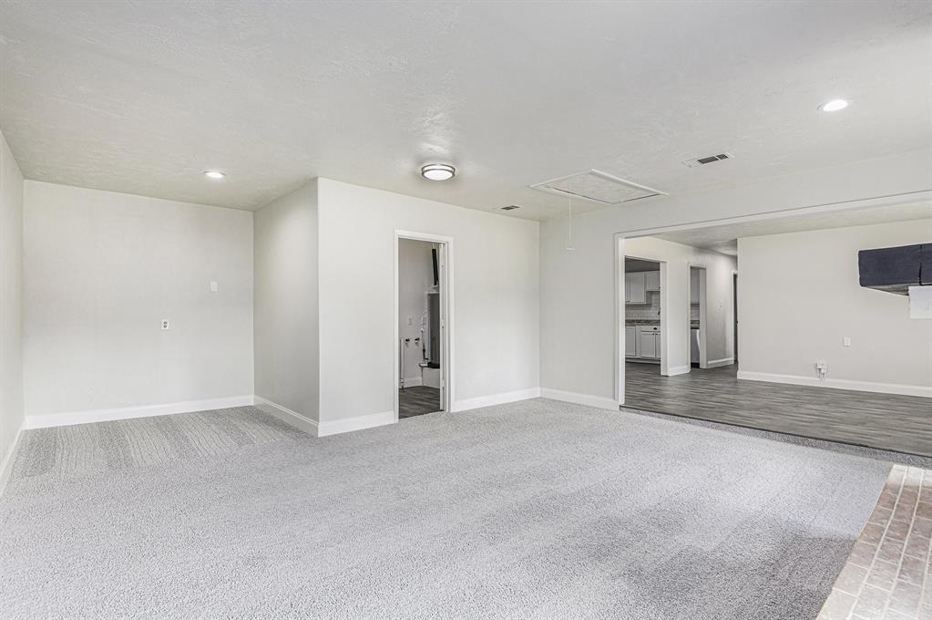 233 Victoria Avenue Azle, TX 76020 - Photo 10 of 25 Unfurnished room featuring light carpet, attic access, and recessed lighting