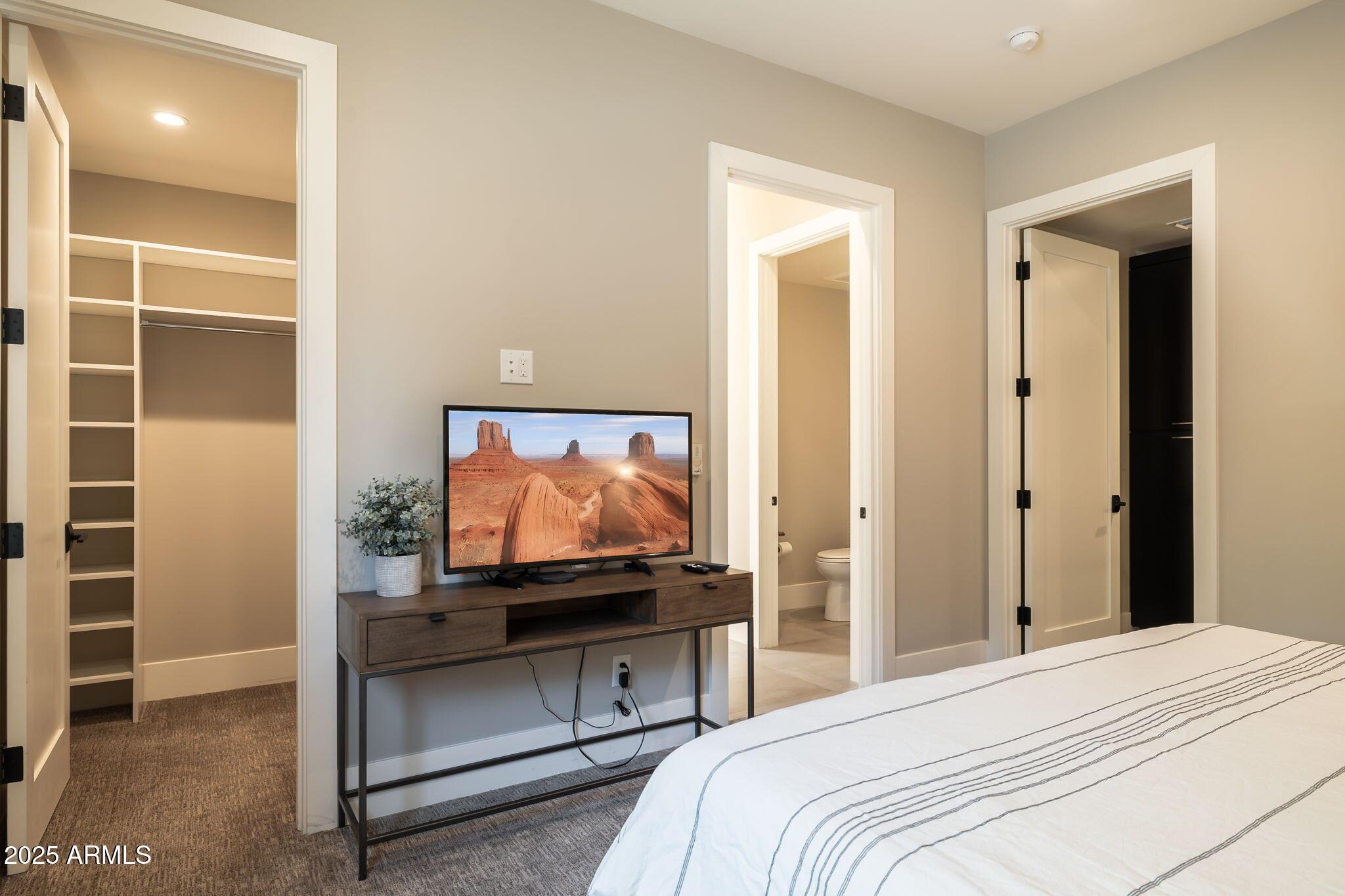 6525 East Cave Creek Road, Unit 31 Cave Creek, AZ 85331 - Photo 33 of 49 a bedroom with a bed and a flat screen tv