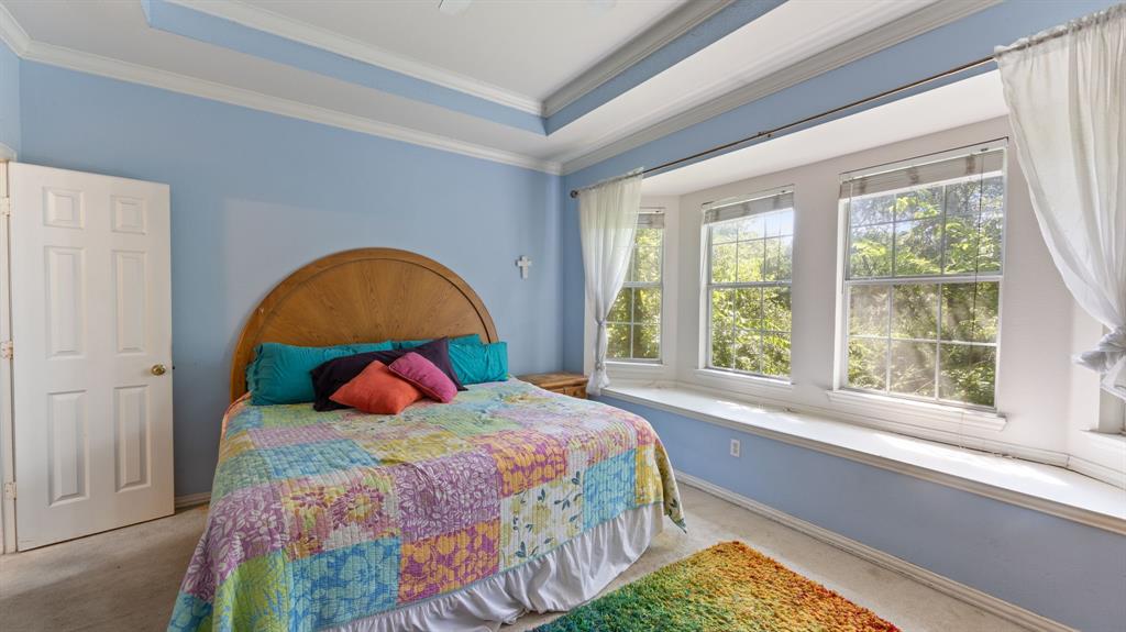1508 Valley Creek Road Denton, TX 76205 - Photo 24 of 33 a bedroom with a bed and a large window