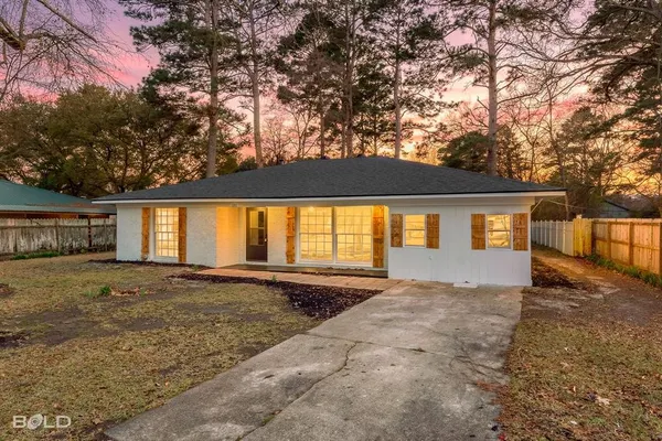 a large house with trees in front of it