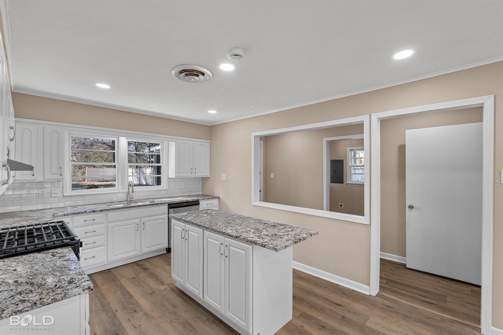 1211 Lee Street Benton, LA 71006 - Photo 13 of 39 a kitchen with a sink stove and cabinets