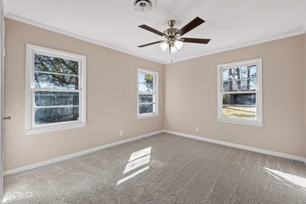 a view of a livingroom with a ceiling fan and window