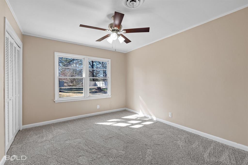 1211 Lee Street Benton, LA 71006 - Photo 21 of 39 a view of a big room with windows and chandelier fan