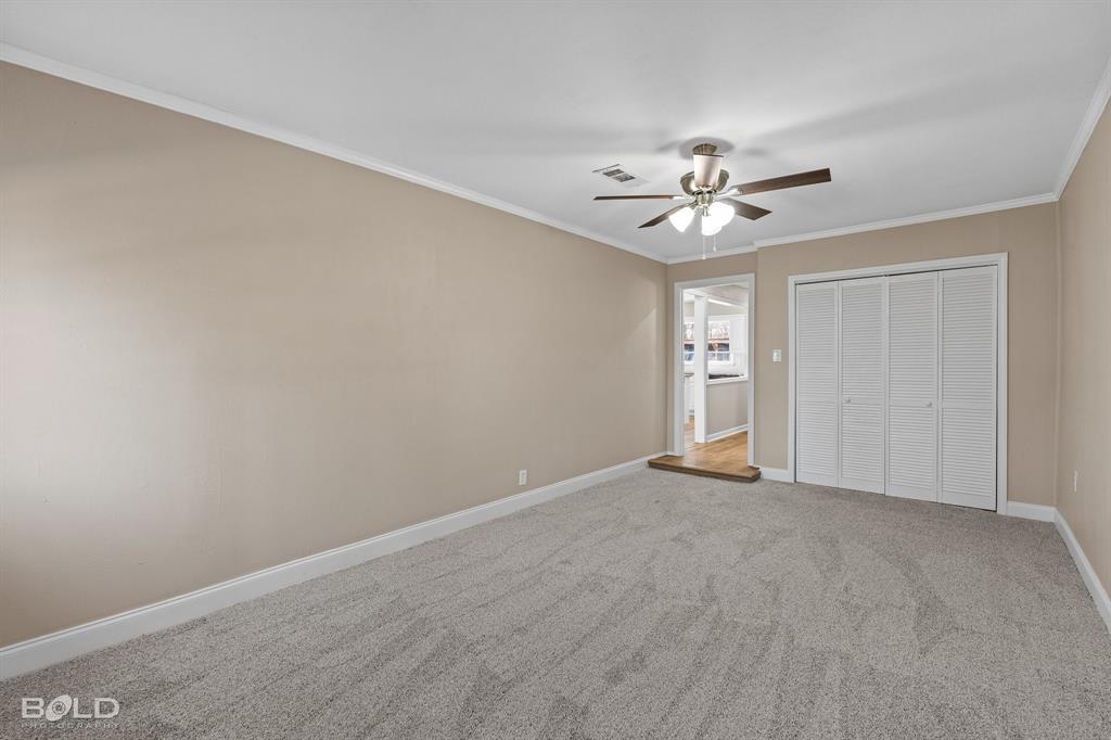 1211 Lee Street Benton, LA 71006 - Photo 24 of 39 a view of an empty room with a ceiling fan and window