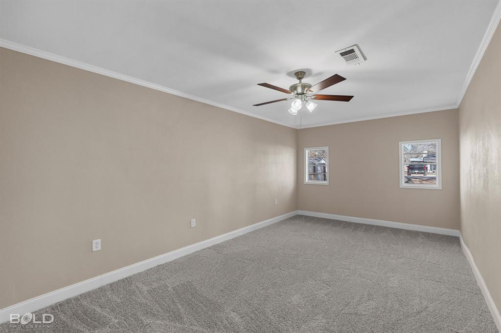 1211 Lee Street Benton, LA 71006 - Photo 25 of 39 an empty room with windows and ceiling fan