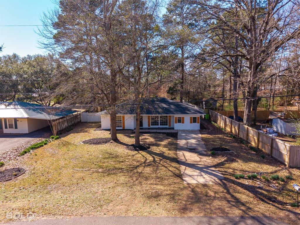 1211 Lee Street Benton, LA 71006 - Photo 4 of 39 a house with trees in front of it