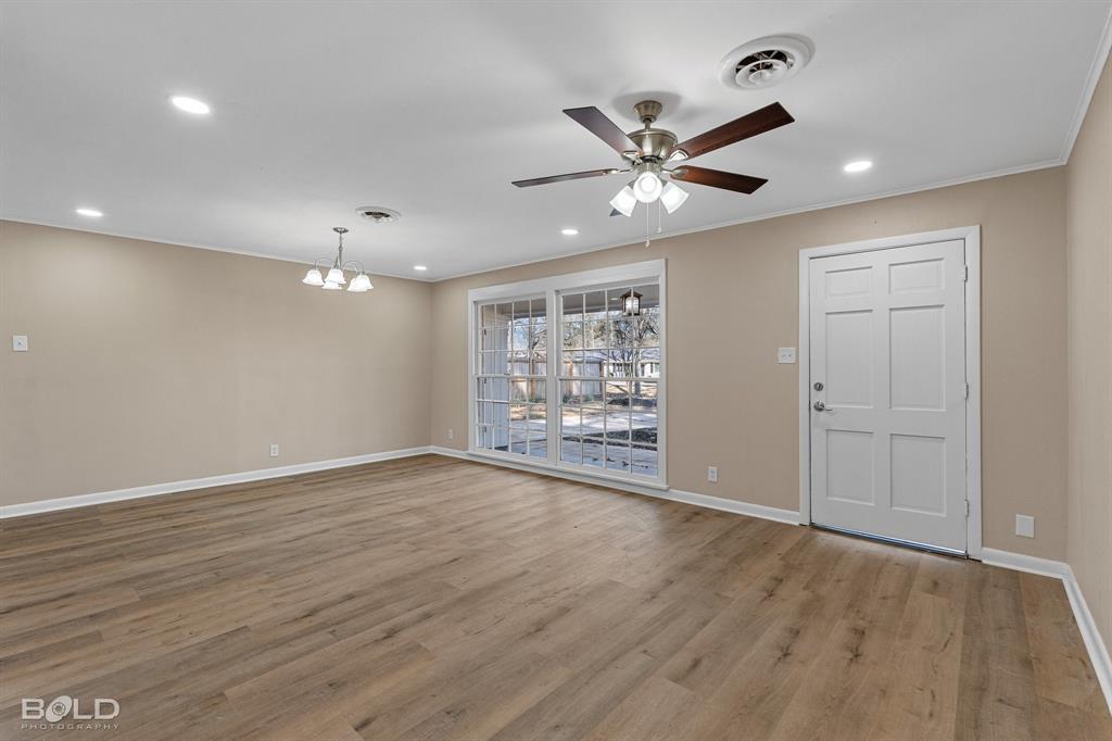 1211 Lee Street Benton, LA 71006 - Photo 6 of 39 a view of an empty room with a window and wooden floor