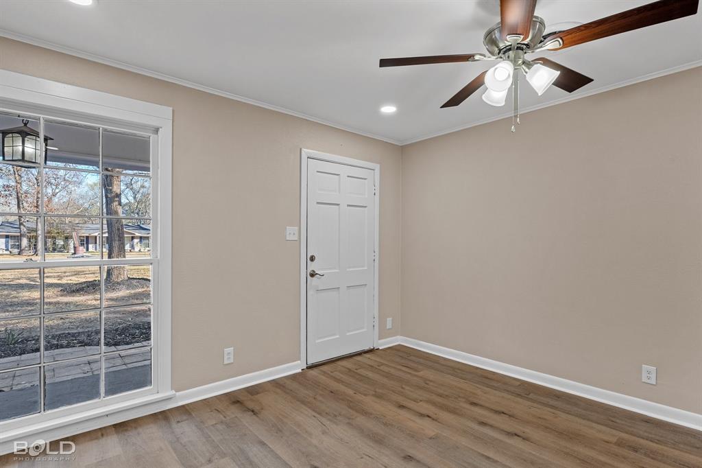 1211 Lee Street Benton, LA 71006 - Photo 7 of 39 wooden floor in an empty room with a window