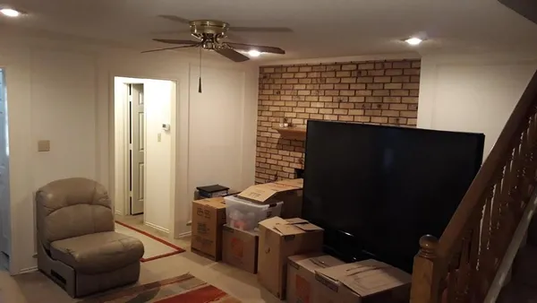 a livingroom with workspace and a couch