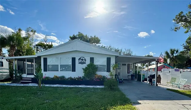 a front view of a house with a garden and plants