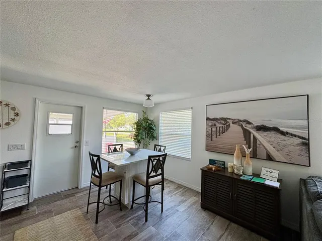 a kitchen with granite countertop a stove top oven sink and cabinets