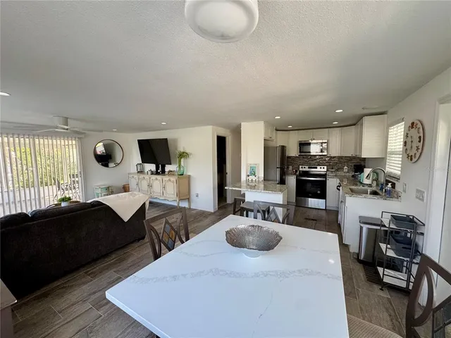 a kitchen with granite countertop a stove and cabinets