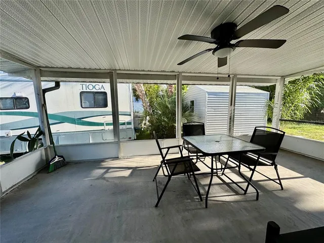 a view of backyard with swimming pool and outdoor seating