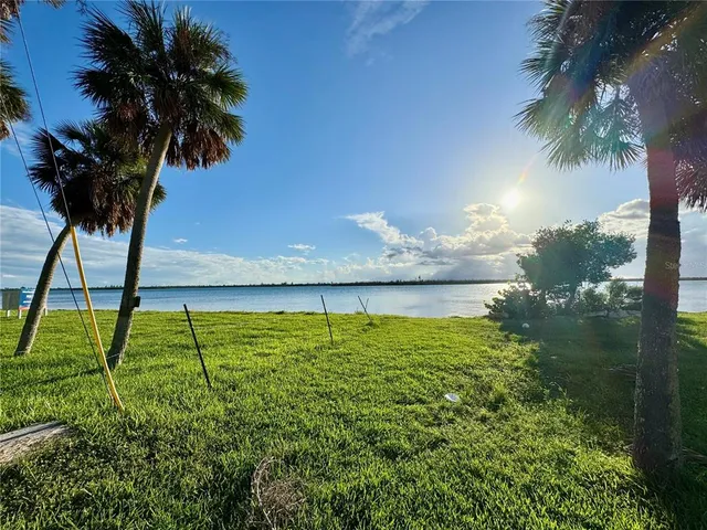a living room with furniture kitchen view and a large window