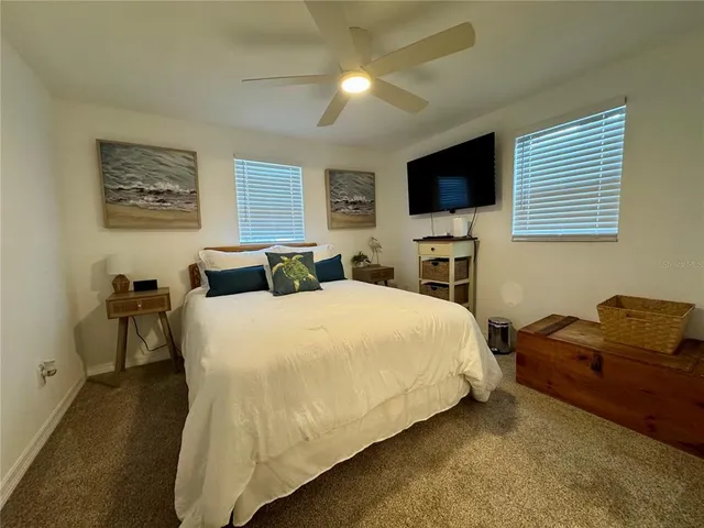 a bedroom with a bed and a mirror