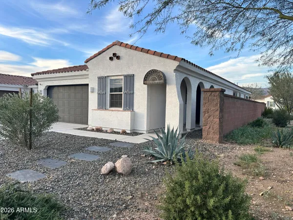 a front view of a house with garden