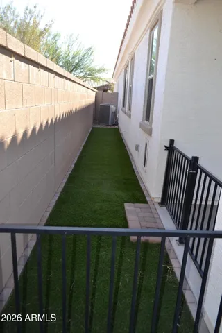 a view of a hallway with a walk in closet and a bathroom